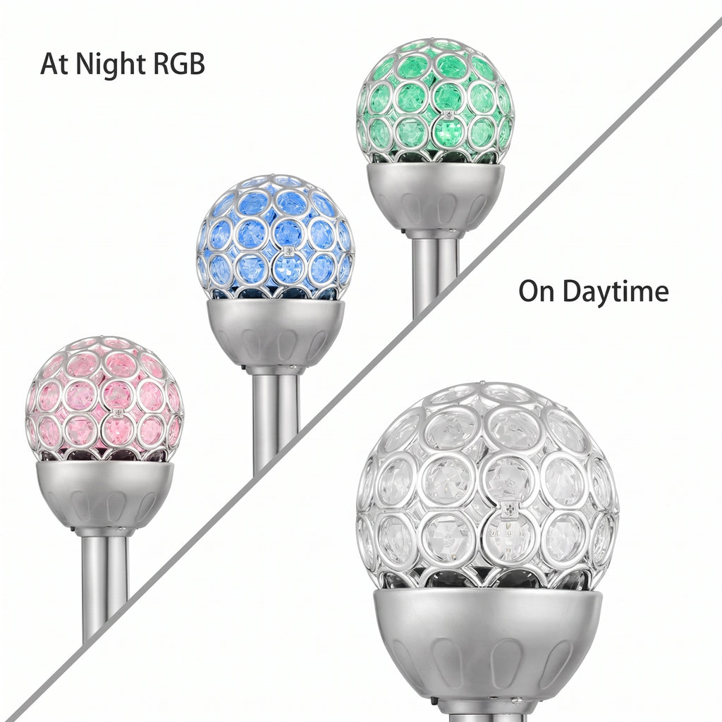 Three solar garden post lights with crystal-embellished spherical heads are shown on a white background, split diagonally by a gray line. The left side reads 'At Night RGB' and shows the lights colored pink, blue, and green.