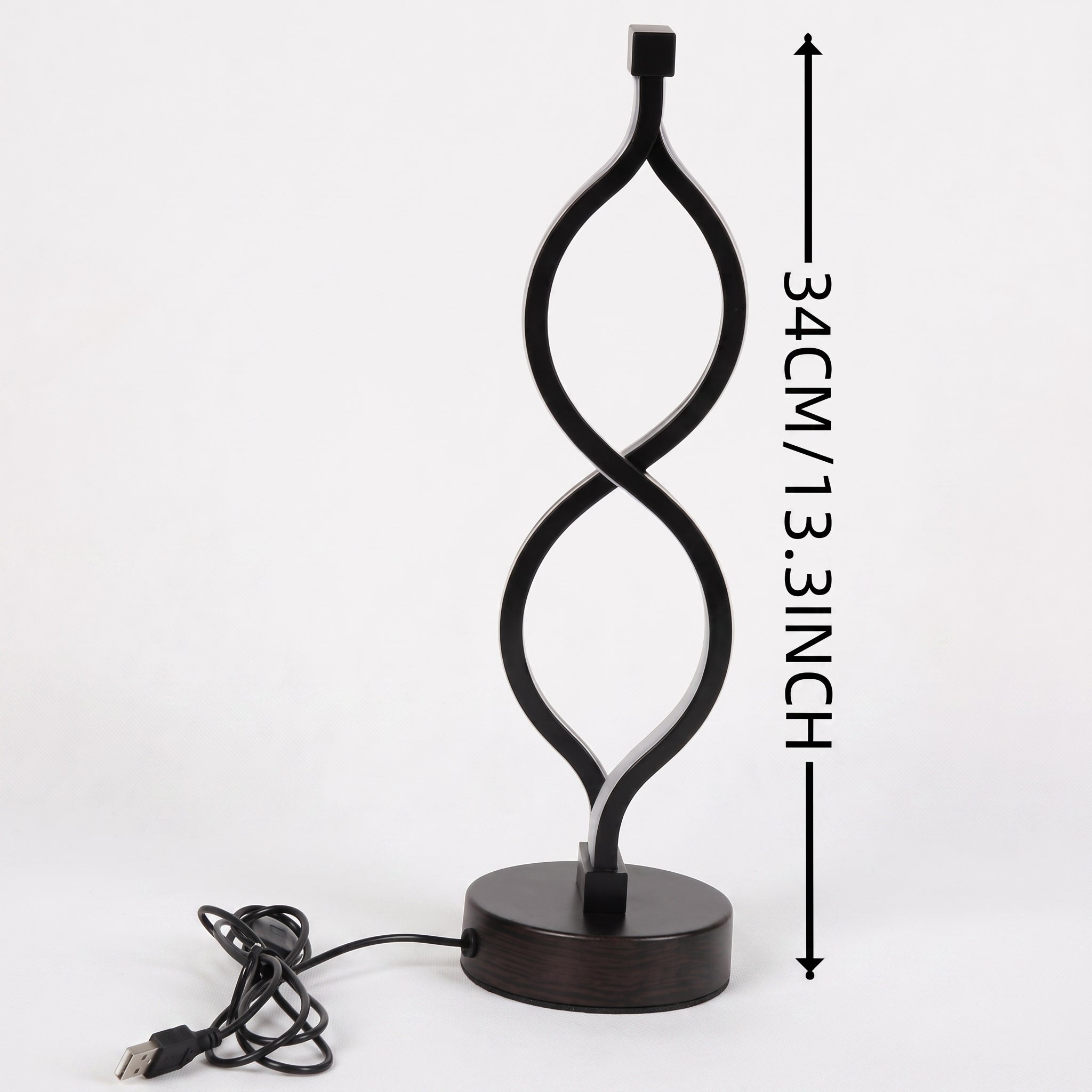 A dark brown spiral LED table lamp with a unique twisted design and a USB cord, set against a white background. The lamp measures 34 CM / 13.3 INCH tall.