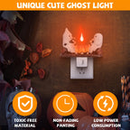 A Halloween-themed ghost night light shown plugged into a wall outlet on a dark wooden surface. The light features two white cartoon ghosts facing each other above a glowing orange pumpkin, with an orange banner at the top reading 'UNIQUE CUTE GHOST LIGHT' and three orange feature icons at the bottom.