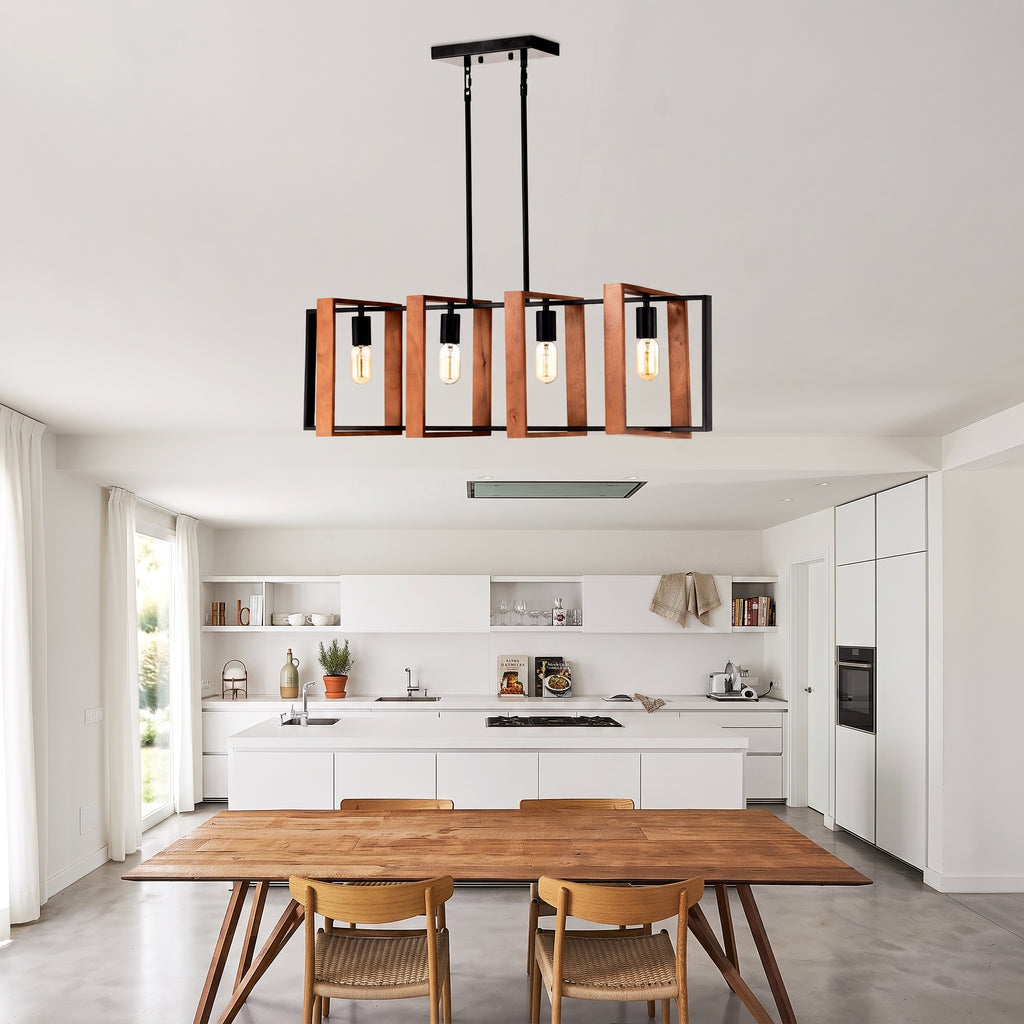 A modern rectangular pendant light fixture with copper-toned vertical frames and black metal structure, hanging over a dining table in a bright contemporary kitchen and dining room.
