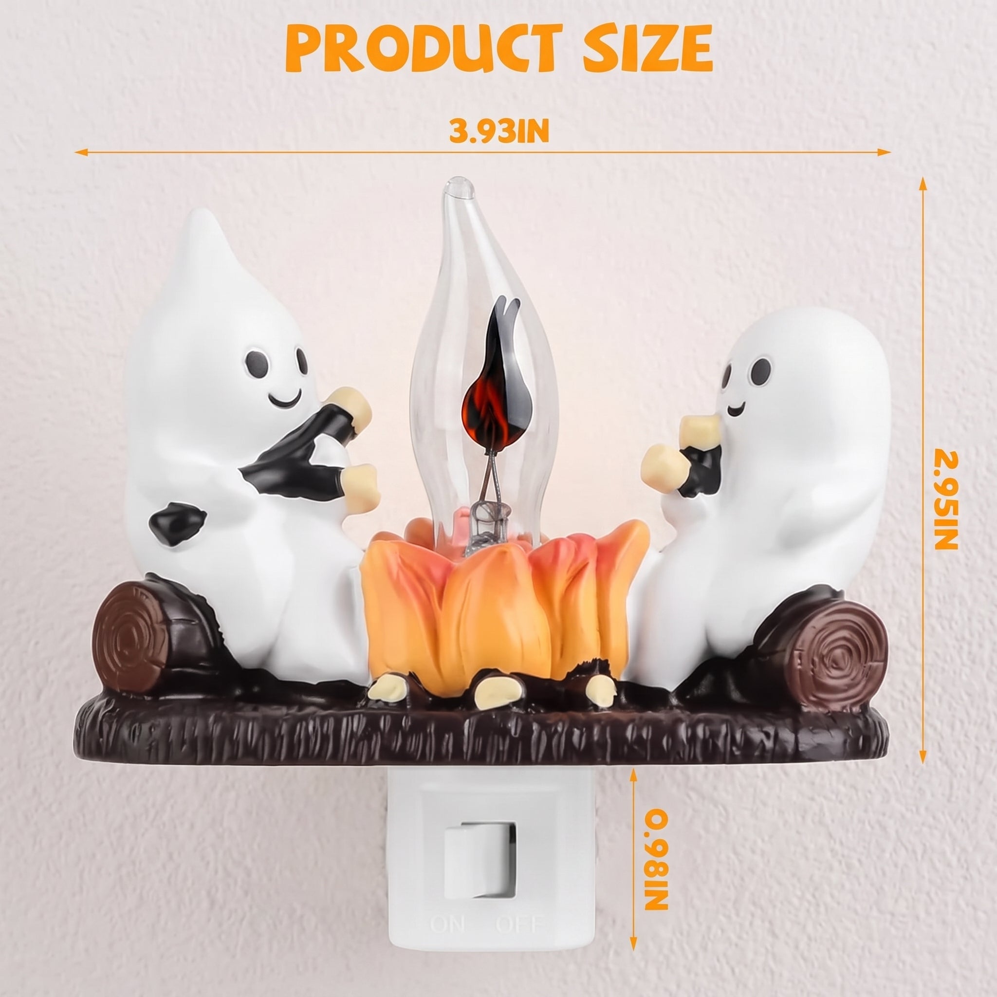 A Halloween night light product with two white cartoon ghosts roasting over a small orange campfire on a dark brown base, shown with overlaid dimension lines and text indicating product size.