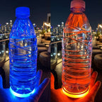 Water bottles resting on Zainzio LED car cup holder coasters glowing with vibrant blue and orange ambient light at night.