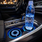 Zainzio LED car cup holder coaster installed in a vehicle center console, glowing blue beneath a water bottle.