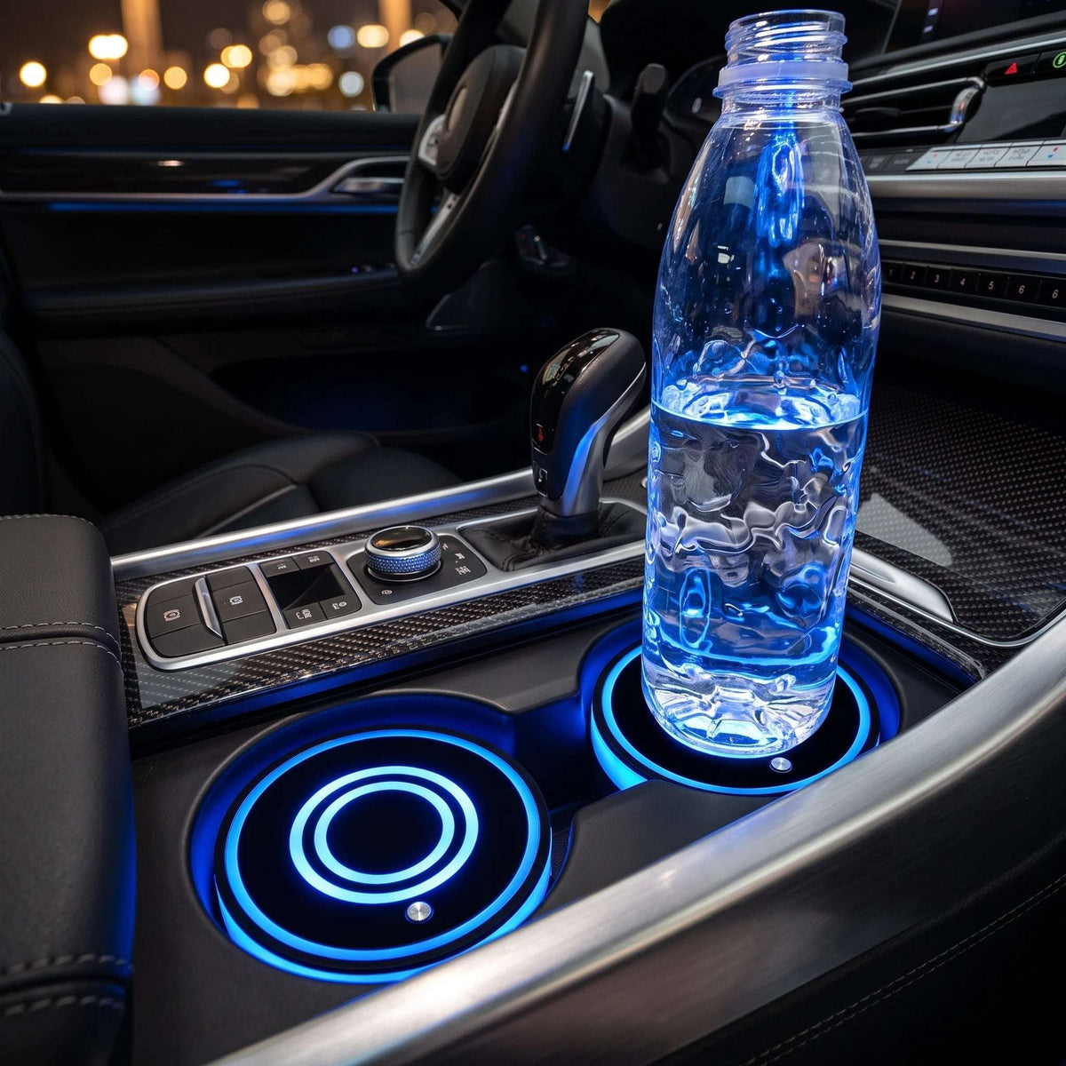 Zainzio LED car cup holder coaster installed in a vehicle center console, glowing blue beneath a water bottle.