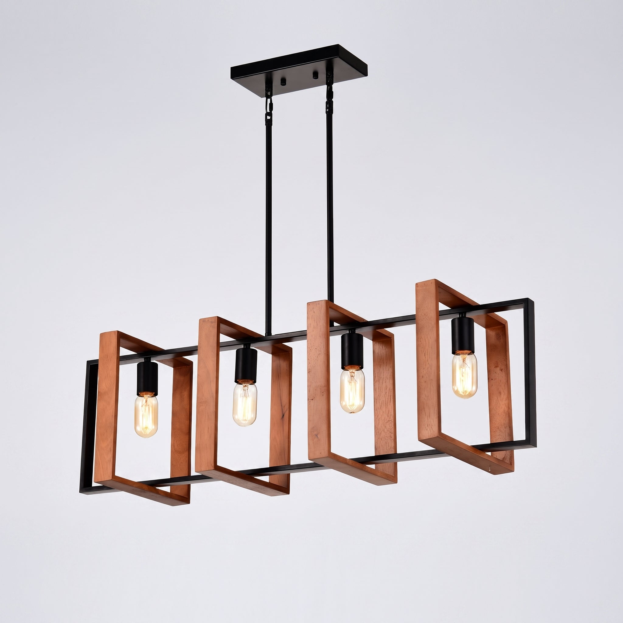 A modern four-light linear chandelier with a black metal frame and warm copper/bronze geometric side guards, suspended from a black ceiling canopy against a light gray background.