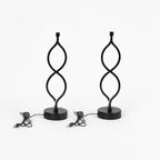 A pair of black Zainzio Spiral LED Table Lamps with a unique twisted design on round bases are shown with their USB power cords.