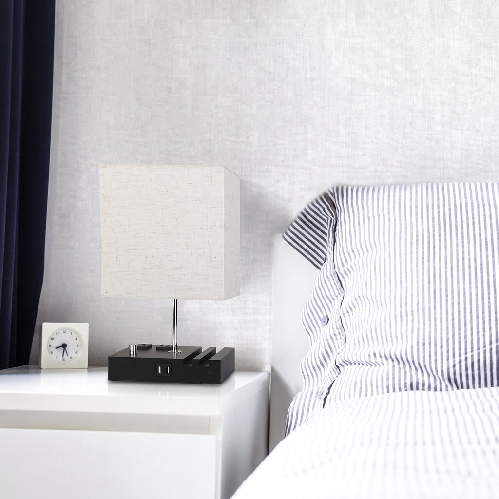Modern bedroom with a bed and nightstand featuring a lamp and clock.