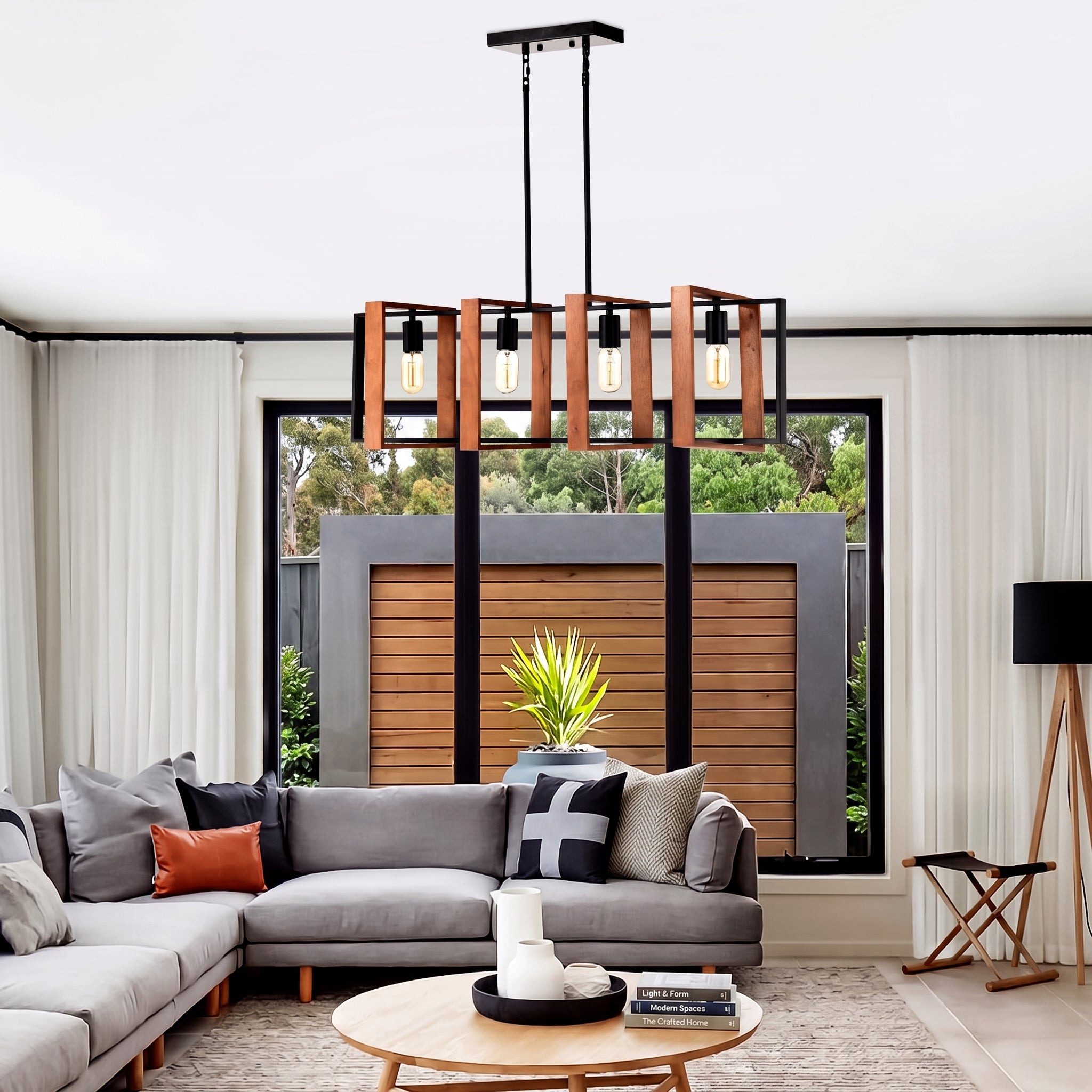 A modern multi-light linear chandelier with warm wood-look rectangular shades and black metal framing, hanging in a contemporary living room above a gray sectional sofa.