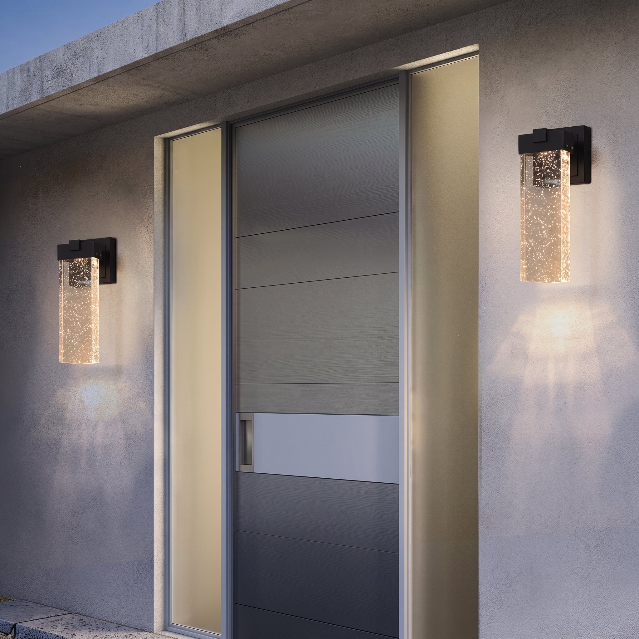 Two modern outdoor wall sconces with textured clear glass and black metal frames, mounted on a concrete building facade flanking a glass door.