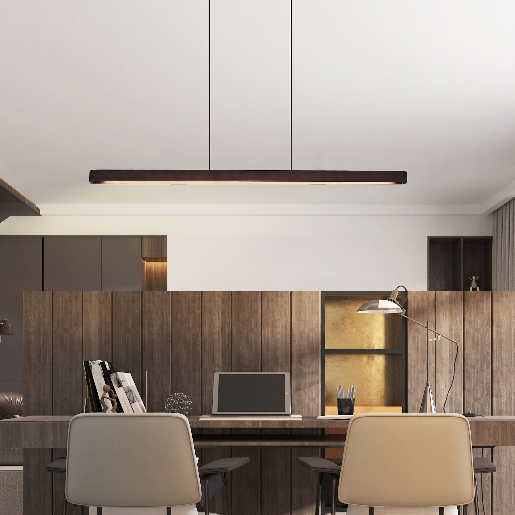 A modern linear LED pendant light with a dark wood frame hangs over a contemporary home office workspace with wooden paneling, chairs, and a desk.