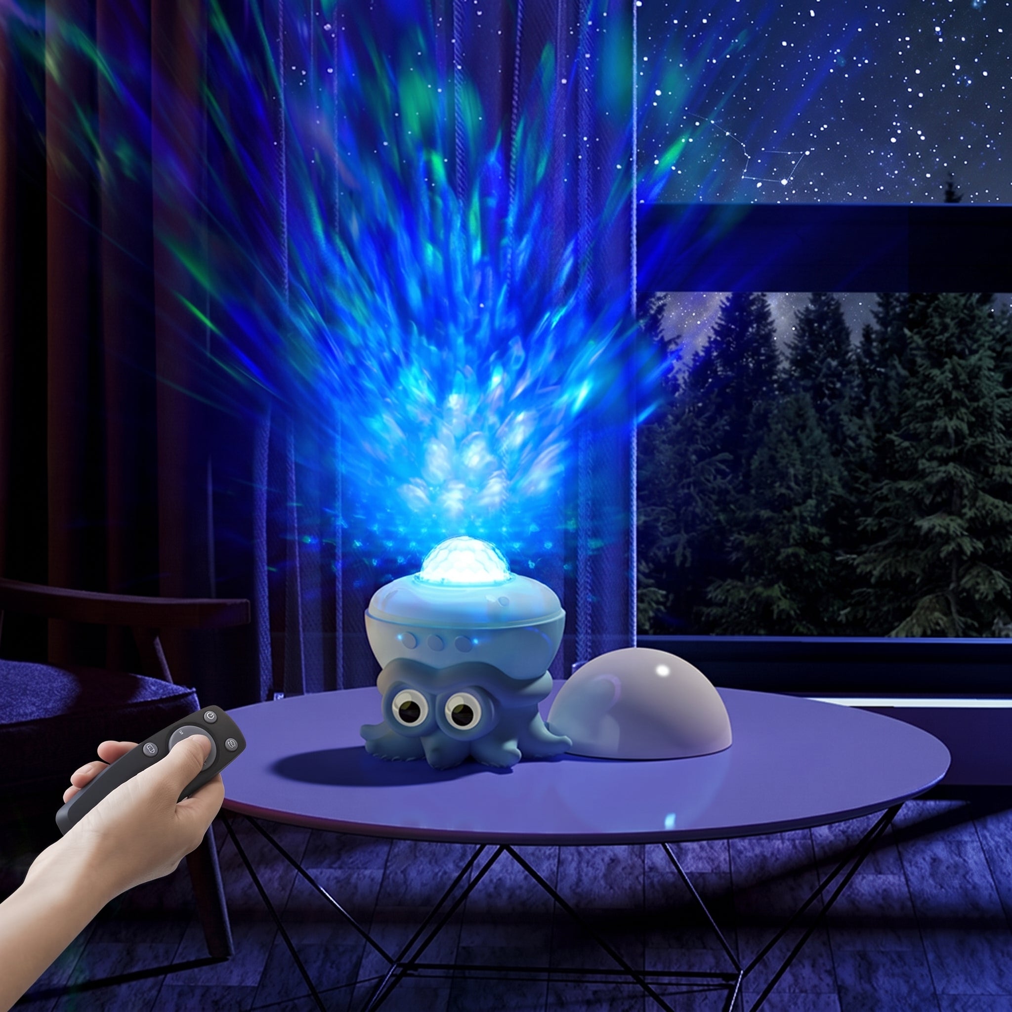 A small octopus-shaped night light sits on a round table in a bedroom, casting bright blue and green starburst projections into the dark room. A hand holds a remote control, and a window behind shows a starry night sky and trees.