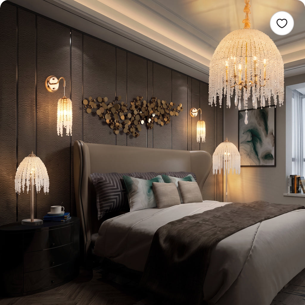A luxury bedroom featuring a large crystal chandelier hanging above the bed, matching crystal table lamps on nightstands, a textured dark wood-paneled wall, and a beige upholstered headboard.