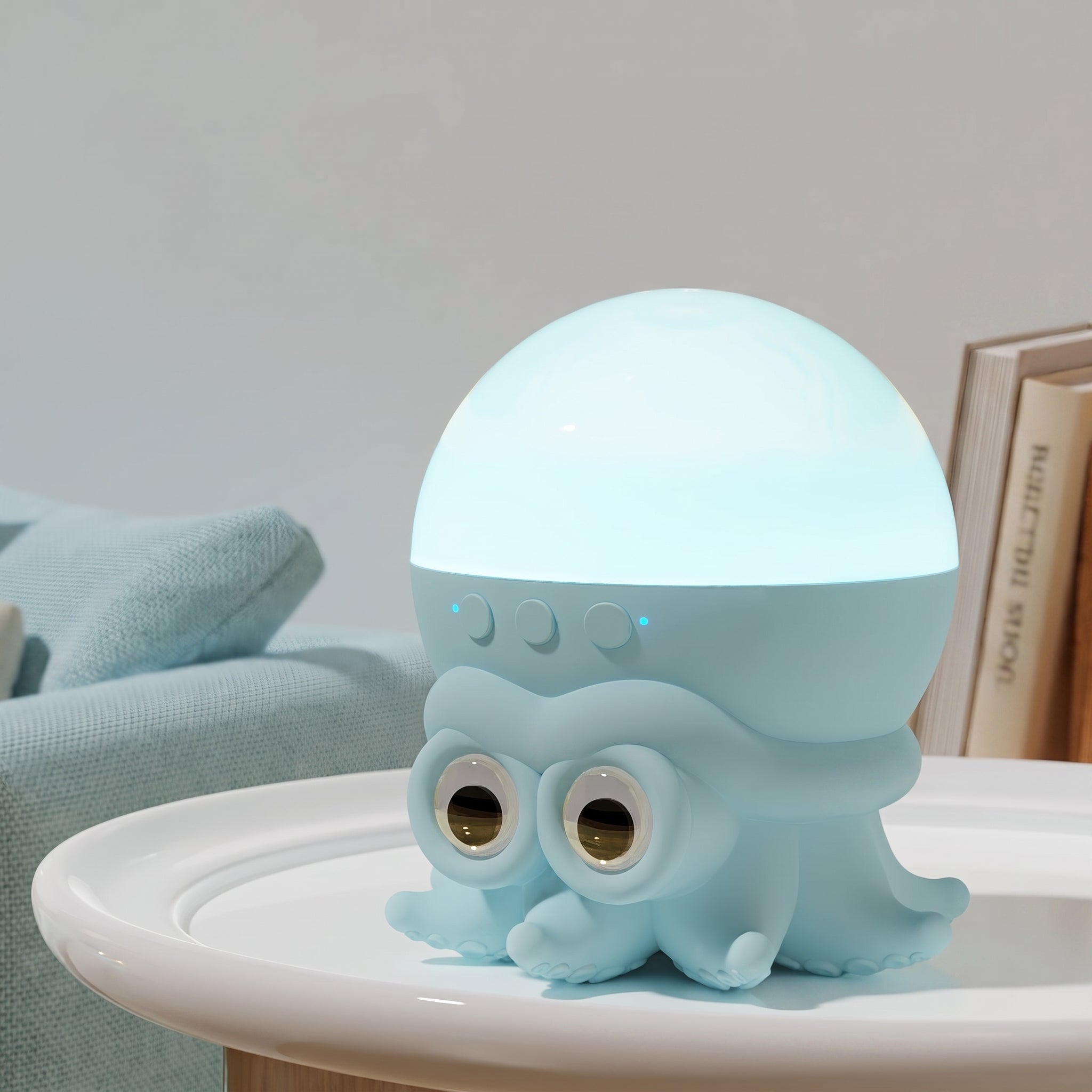 A cute light blue octopus-shaped night light with a glowing dome on top, sitting on a white table in a cozy room setting.