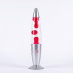 A classic lava lamp with a clear glass body showing red wax flowing, topped with a silver metal cap and base on a white background.