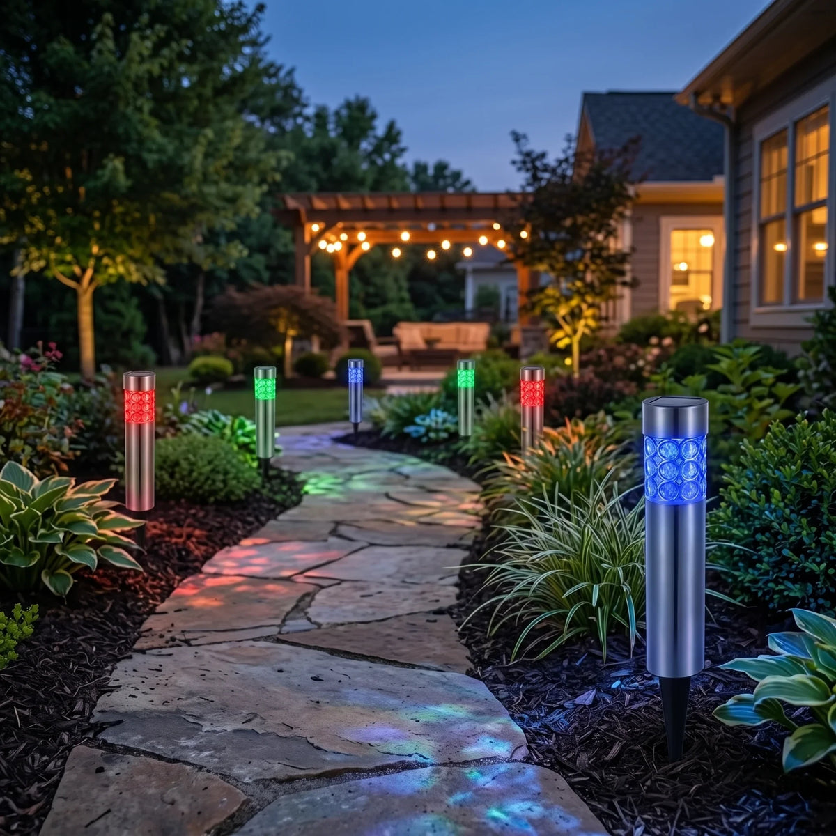 Zainzio RGB solar garden stake lights glowing in red, green, and blue along a stone path in a backyard at twilight.