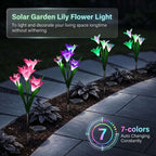Zainzio solar lily garden lights with color-changing LED blooms in pink and purple along a stone walkway at night.