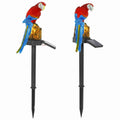Two solar-powered parrot decorations on stakes with a white background