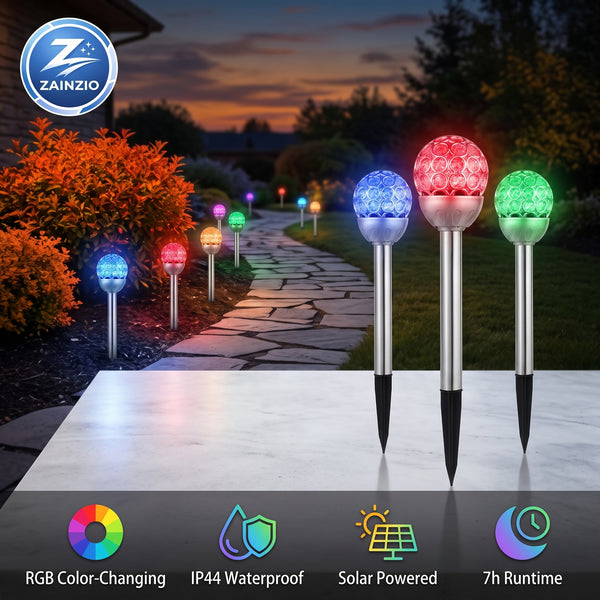 RGB solar garden path lights shown in a backyard garden pathway at dusk, with three lights illuminated in blue, red, and green on a metal stake. Features a ZAINZIO brand logo and feature icons at the bottom.