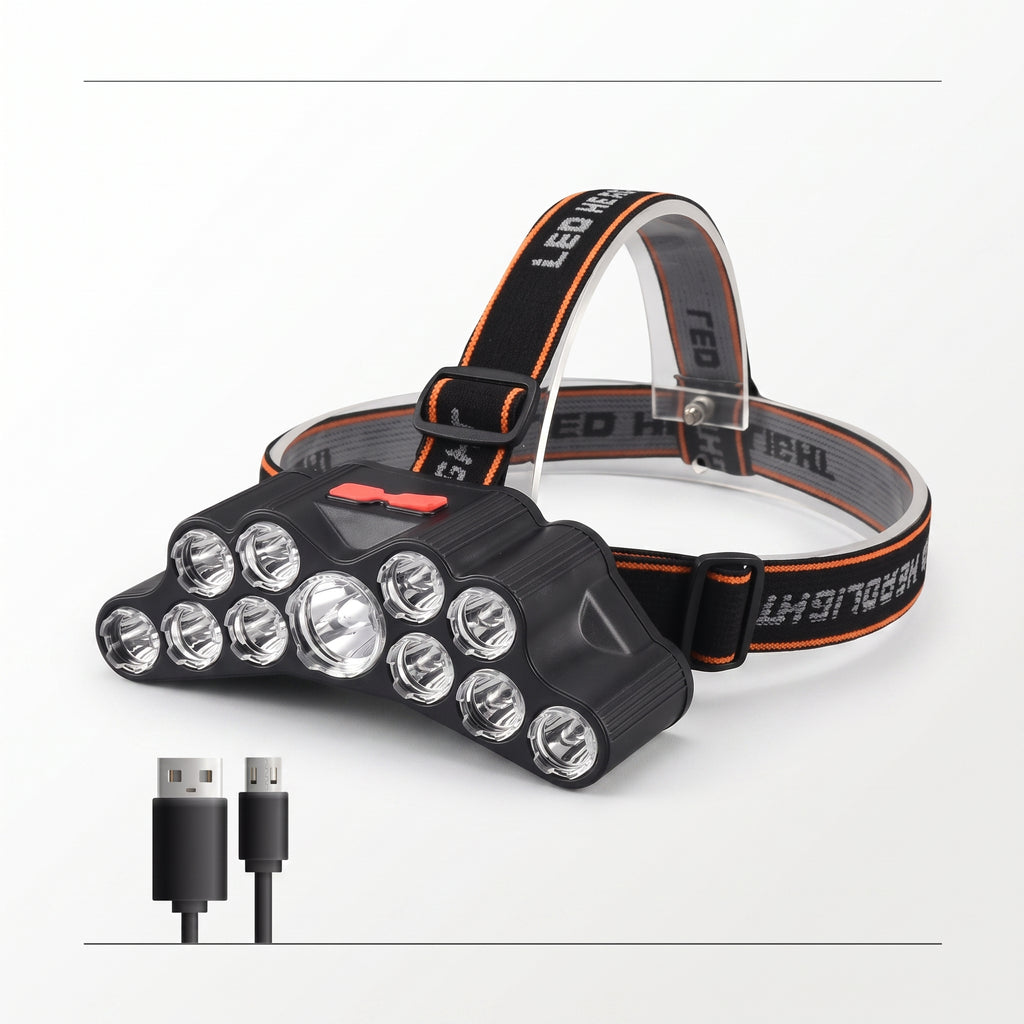 A black LED headlamp with multiple clear lenses and a black adjustable strap with orange stitching, shown on a white background with two small USB charging cables below it.