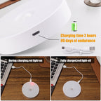 A white circular wireless charging pad shown in a close-up and in use on a wooden desk with a laptop. Text overlays state 'Charging time 2 hours 90 days of endurance' and show the charging light on during charging and off when fully charged.