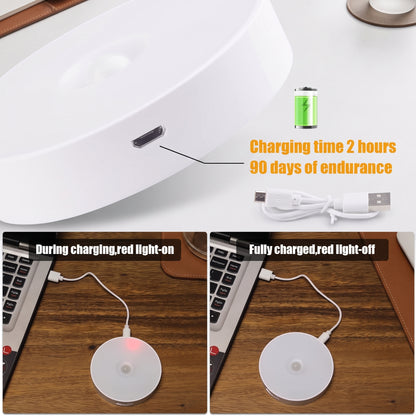 A white circular wireless charging pad shown in a close-up and in use on a wooden desk with a laptop. Text overlays state 'Charging time 2 hours 90 days of endurance' and show the charging light on during charging and off when fully charged.